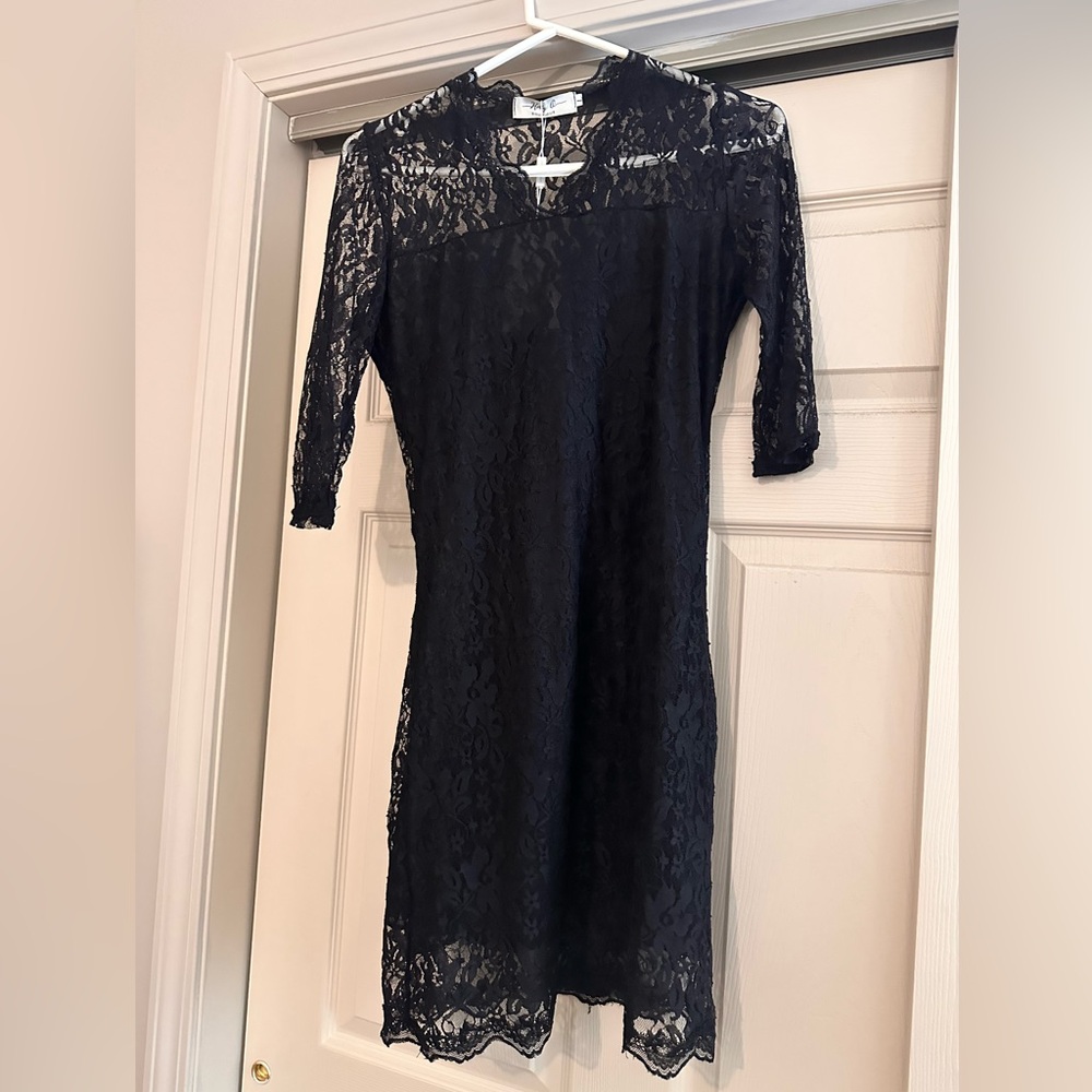 Lace style, below the knee , 3 quarter sleeve never worn.